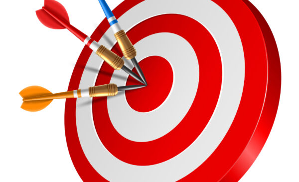 Red dart arrow hitting in the target center of dartboard Red dart arrow hitting in the target center of dartboard